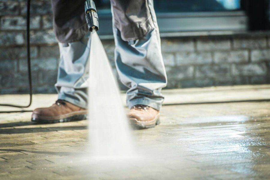 Pressure washing a paver driveway